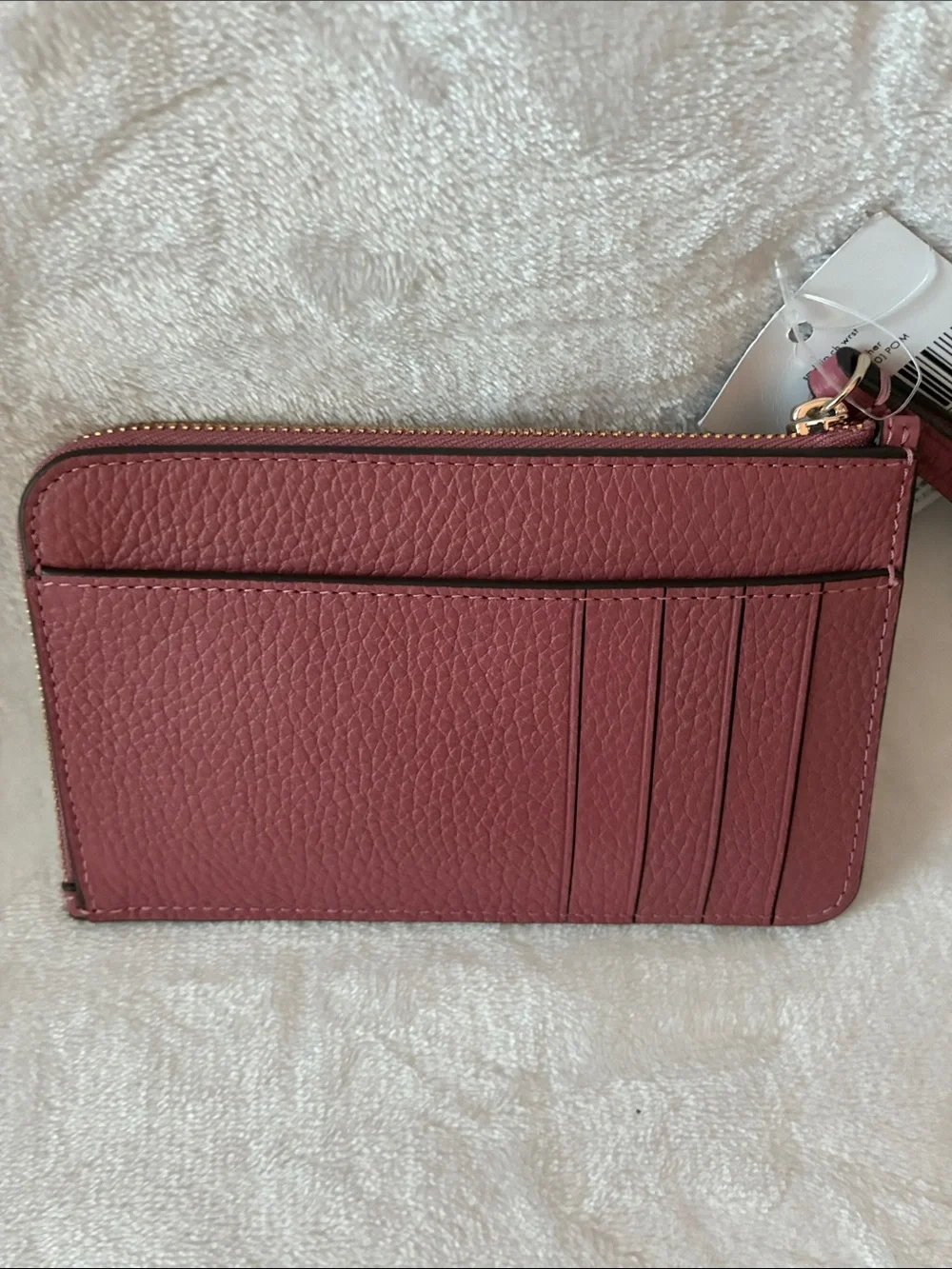 kate spade pebbled leather wristlet in dusty rose with gold logo